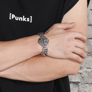 Detailed view of 304 stainless steel skull bracelet in antique silver on male wrist