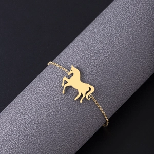 Golden stainless steel unicorn bracelet with delicate adjustable chain on display