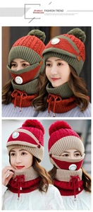 Close-up of thick knit beanie with fur pompom, respirator mask and adjustable neck gaiter