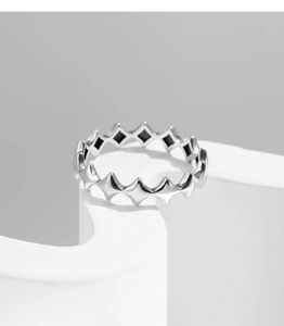 Detailed view of S925 sterling silver star-shaped geometric ring on a minimalist pedestal