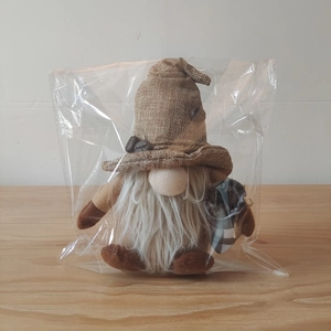 Detailed close-up of a coffee gnome doll with a burlap hat and coffee bean accents