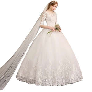 Elegant off-shoulder lace wedding dress with sheer sleeves and a long bridal veil