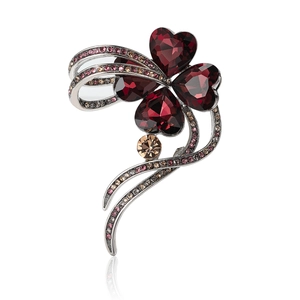 Elegant silver four-leaf clover brooch with red heart crystals and sparkling rhinestones