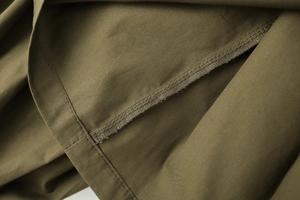 Detailed close-up showing army green cotton poplin fabric and durable double-stitch seams