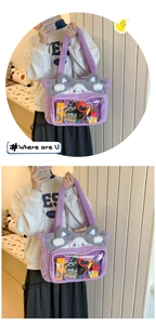 Detail of purple plush cat-ear tote bag featuring a clear PVC window for display