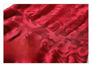 Détail de la dentelle florale rouge avec couture à la taille et texture en maille
