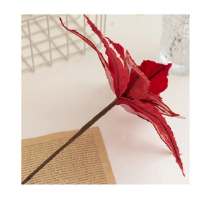 Close-up of red sequined Christmas flower with gold glitter edges for festive wreaths