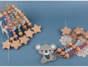 Detail of beech wood clips and food-grade silicone beads on colorful pacifier chains