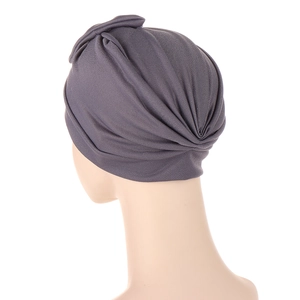 Dark grey knitted turban hat with pleated design and elegant front cross bow detail