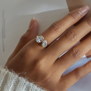 Close-up of 18K gold stainless steel Toi et Moi ring featuring pear and round zircon stones