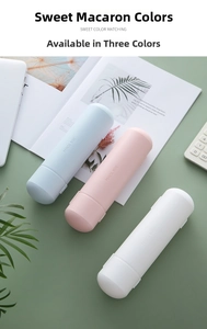 Capsule-shaped pencil cases in pastel pink, blue, and white on a green desk setup