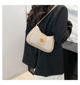 Detail of beige underarm bag with gold oval twist lock and fabric-PU mix texture