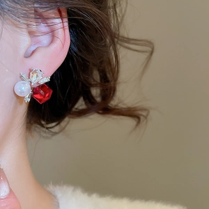 Close-up of vintage square red crystal and pearl earring with silver base details