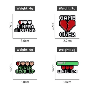 Detail view of pixel art enamel pins with Game Over and Level Up text on white background
