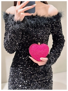 Macro shot of rose pink heart-shaped evening clutch bag with sparkling rhinestones