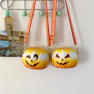 Detail of two pumpkin shaped crossbody bags in yellow orange gradient with metal hardware