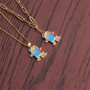Detailed view of gold bear pendants with micro-pave zircons and enamel on two different chains