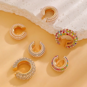 Detail view of gold C-shape ear cuffs featuring pearls, rhinestones and colorful zircons
