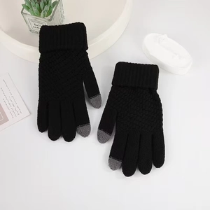 Close-up of black knit gloves showing grey conductive tips for touchscreen sensitivity