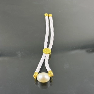 Adjustable Milanese rope bracelet featuring a large white pearl and gold metal hardware
