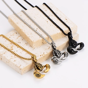 Three scorpion pendant necklaces in gold, silver and black on beige stone