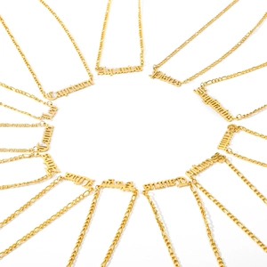 Close-up of 12 gold stainless steel zodiac necklaces with Gothic style lettering detail