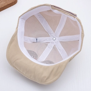 Close-up of baby sun hat interior showing breathable white mesh lining and neat stitching