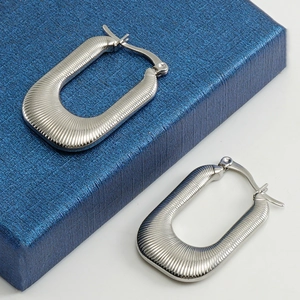 Silver U-shaped textured metal earrings with ribbed vertical pattern in geometric style