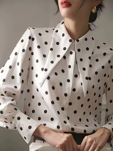 Elegant white polka dot blouse with long lantern sleeves and a classic pointed collar