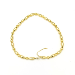 Macro shot of gold-plated bamboo-style beads chain with lobster clasp and extension
