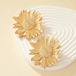 Exaggerated gold sunflower earrings with layered petals and textured metallic finish
