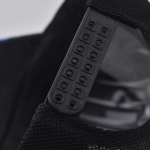 Detailed close-up of adjustable double-row plastic snapback closure on mesh hat