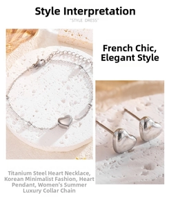 Close-up of minimalist heart-shaped titanium steel jewelry set on white marble stone