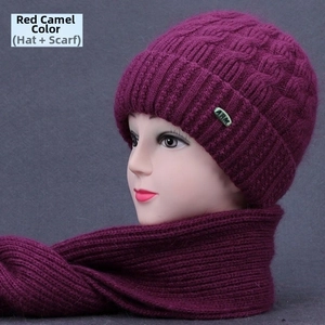 Detailed close-up of wine red knitted winter hat and scarf set with thick cable pattern