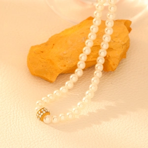 Vintage 18k gold plated pearl necklace with a shimmering diamond-set cylinder charm