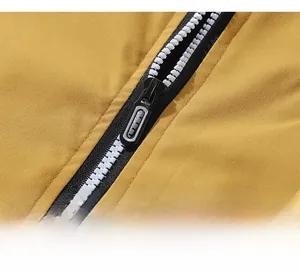 Detail of smooth black resin zipper on yellow baseball jacket with high-contrast design