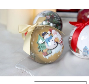 Close-up of festive Christmas foam ball ornaments with Santa and Snowman prints and bows