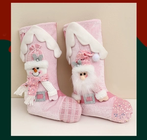 Detail of pink Christmas stockings featuring sequined Santa and snowman plush characters