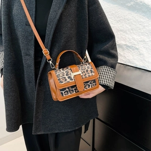 Fashionable leopard print crossbody bag with brown leather trim and top handle
