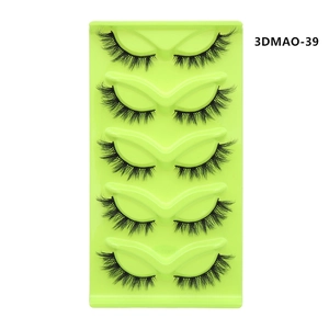 Detailed view of five pairs of 3D cat-eye false eyelashes in a bright green tray
