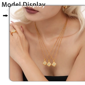 Close-up of three-layer gold necklace and ring set with blue gemstone rhombus charms