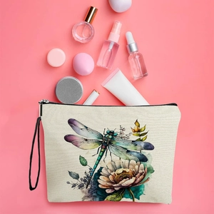 Watercolor dragonfly canvas makeup bag with black zipper and strap on pink background