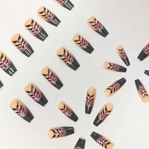 Long coffin press-on nails with pink-purple gradient and black feather leaf patterns