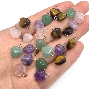 Assorted heart-shaped natural stone pendants including tiger eye and rose quartz stones