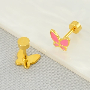 Polished butterfly stud earrings in gold finish with pink enamel on marble background