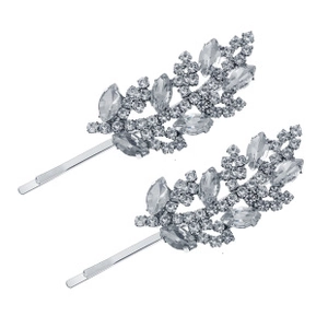 Macro detail of two silver leaf hair clips with sparkling rhinestones on white background