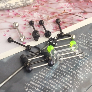 Detail shot of various stainless steel tongue rings with skull and rose motifs
