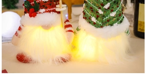 Detail showing the warm LED glowing effect on holiday gnomes with knitted hats