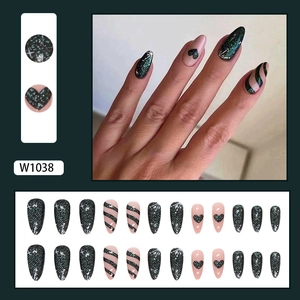 Glitter almond fake nails with heart and stripe patterns in black aurora finish