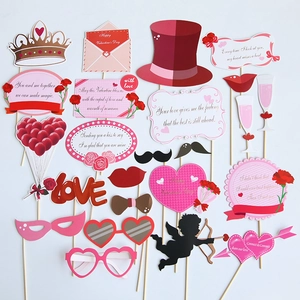 Close-up of Valentine's Day photo booth props including pink hearts and paper red lips